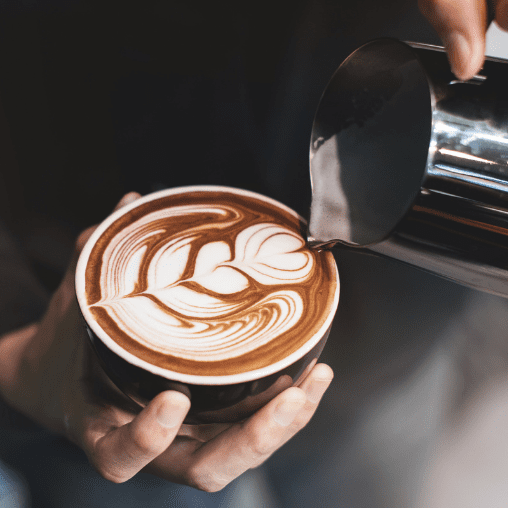 A barista pouring cup of coffee
